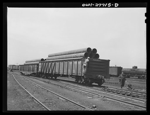 Bensenville, Illinois. Switching carloads of pipe for the "Big Inch" pipeline, for transfer to eastern railroads by the Chicago, Milwaukeem Saint Paul and Pacific Railroad