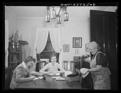Untitled photo, possibly related to: Niagra Falls, New York. Mrs. Hannegan (right) runs a boardinghouse for girls who work in war plants. Her daughter Nan, nineteen, a chemical operator in the Niacet Chemical Company, and another girl writing letters
