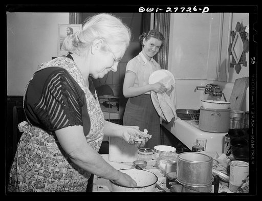 Niagara Falls, New York. Mrs. Hannegan runs a boardinghouse for girls who work in war plants. Her daughter, Nan (right) nineteen, who works as a chemical operator at the Niacet Chemical Company is the youngest of eleven children and the only one unmarried. They are washing the supper dishes