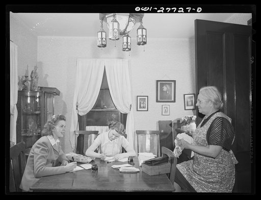 Niagara Falls, New York. Mrs. Hannegan (right) runs a boardinghouse for girls who work in war plants. Her daughter Nan, nineteen, a chemical operator in the Niacet Chemical Company, and another girl writing letters