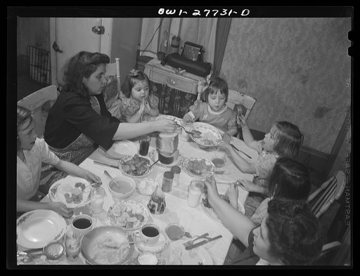 Buffalo, New York. The Grimm family eating Sunday dinner. Mrs. Grimm, a twenty-six year old widow, is a crane operator at Pratt and Letchworth. The two youngest children live in a foster home during the week