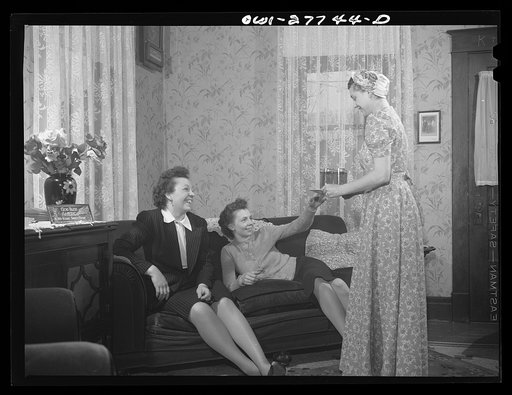 Untitled photo, possibly related to: Buffalo, New York. Laura Czaya passing cherry pop to her two sisters-in-law who have dropped in on Sunday afternoon. Laura's husband is a Corporal stationed in Arkansas. She works in Symington-Gould, makers of tank, ship, and railroad parts. The sisters-in-law al