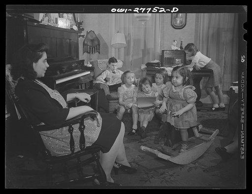 Buffalo, New York. The Grimm family sitting in the living room after supper on a Sunday evening. Mrs. Grimm, a twenty-six year old widow, is a crane operator at Pratt and Letchworth. The two youngest children live in a foster home during the week