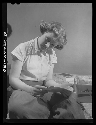 Untitled photo, possibly related to: Niagara Falls, New York. Nan Hannegan, a nineteen-year-old chemical operator at the Niacet chemical company, earning thirty-nine dollars a week, corresponds with about twenty-six servicemen. She is engaged to an Army man