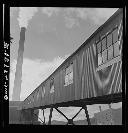 Untitled photo, possibly related to: Morenci, Arizona. Conveyor galleries where ore is transported to the smelter plant in the background