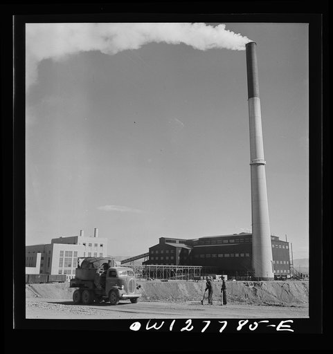 Untitled photo, possibly related to: Morenci, Arizona. The copper mine railroad on which the ore is transported to the smelting plant of the Phelps Dodge mining corporation. The plant is in the background