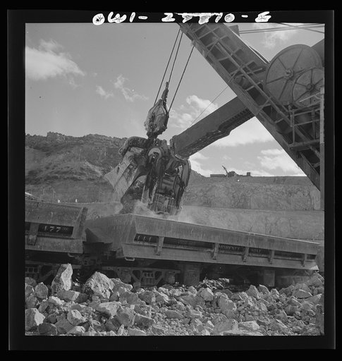 Morenci, Arizona. A huge electric shovel at an open-pit copper mine loading an ore train on its way to the smelter plant of the Phelps Dodge mining corporation
