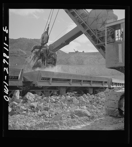 Morenci, Arizona. A huge electric shovel at an open-pit copper mine loading an ore train on its way to the smelter plant of the Phelps Dodge mining corporation