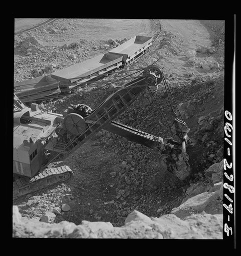 Morenci, Arizona. A huge electric shovel loads an ore train at an open-pit copper mine of the Phelps Dodge mining corporation