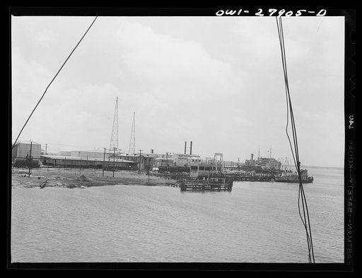 Untitled photo, possibly related to: Barges loading oil at a refinery. Baytown, Texas
