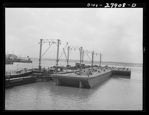 Barges loading oil at a refinery. Baytown, Texas