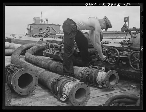 Untitled photo, possibly related to: Baytown, Texas. Loading a barge with oil at a refinery