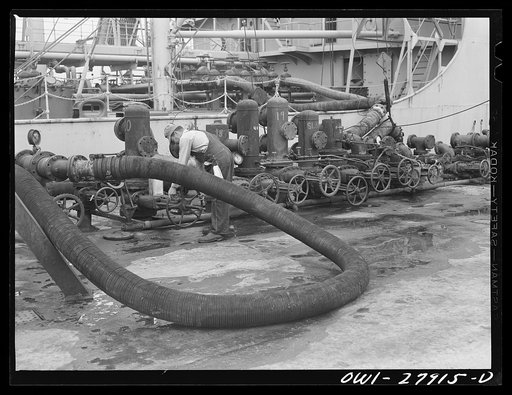 Untitled photo, possibly related to: Baytown, Texas. Loading a barge with oil at a refinery