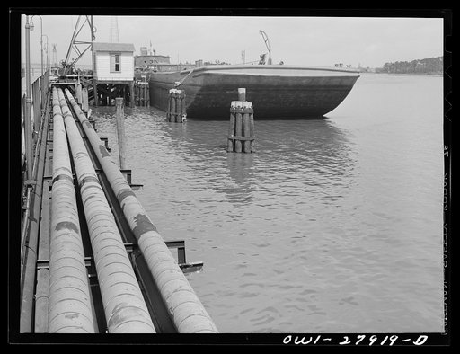 Baytown, Texas. Barge which is being loaded with oil at a refinery