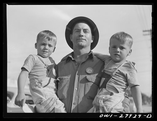 Orange, Texas. Shipyard worker with his two sons whom he called for at the nursery