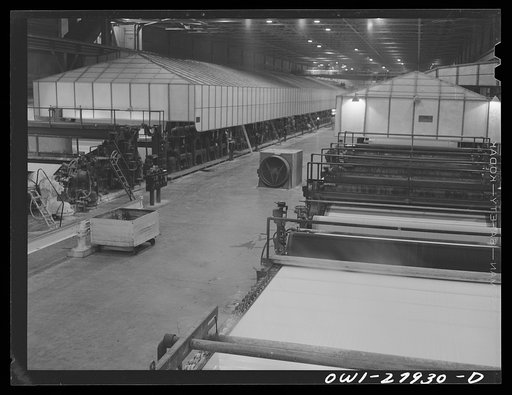 Untitled photo, possibly related to: Houston, Texas. Dry end of a Kraft paper making machine at the Champion paper company. The paper is cut into square sheets as it comes out this end of machine