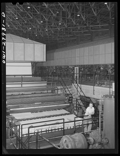 Houston, Texas. Dry end of a Kraft paper making machine at the Champion paper company. The paper is cut into square sheets as it comes out this end of machine