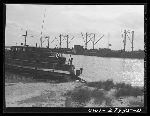Untitled photo, possibly related to: Barges loading oil at a refinery. Baytown, Texas