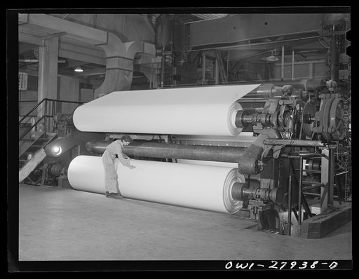 Houston, Texas. Woman attendant at the dry end of a paper machine
