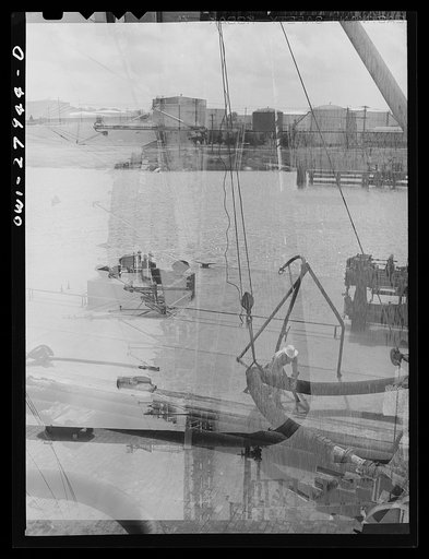 Untitled photo, possibly related to: Baytown, Texas. Loading a barge with oil at a refinery
