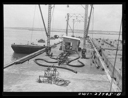 Untitled photo, possibly related to: Barges loading oil at a refinery. Baytown, Texas