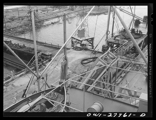 Untitled photo, possibly related to: Baytown, Texas. Loading a barge with oil at a refinery