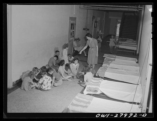 Orange, Texas. In the extended school day-program in the public schools, some children of families where both parents are employed come to school as early as 6 a.m. to enable the parents to get to work. They go back to bed on cots in the school corridor. Then they get up and go through the regular s