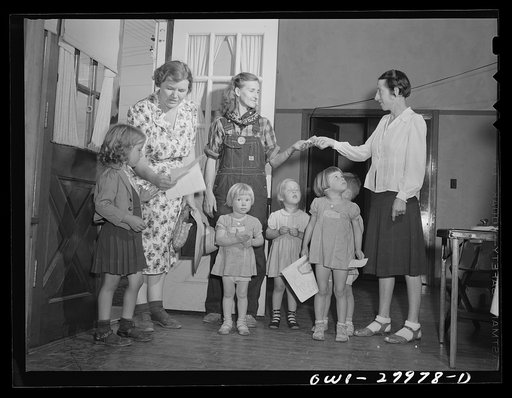Untitled photo, possibly related to: Orange, Texas. Mother who works in the shipyard calling for her daughter at the nursery school at 6 p.m.