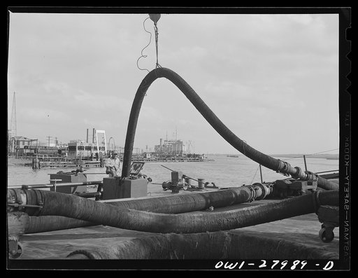 Baytown, Texas. Barge being loaded with oil at a refinery