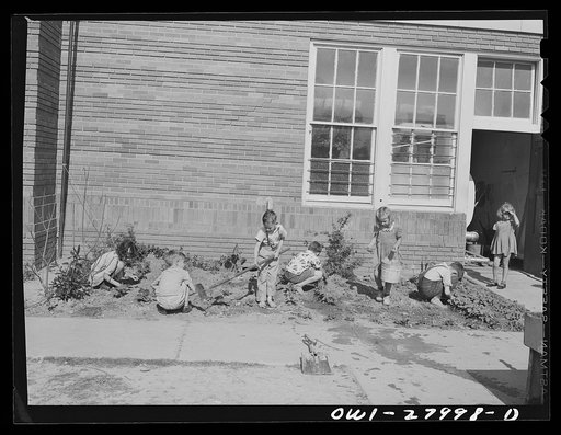 Orange, Texas. Extended school day program in the public schools. These children are working on their garden after the regular school day is over, waiting for their parents to finish work and call for them