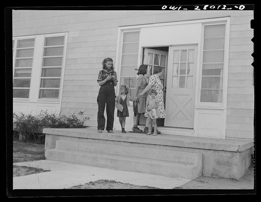 Orange, Texas. Mother who works in the shipyard calling for her daughter at the nursery school at 6 p.m.
