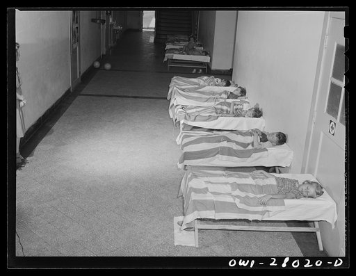 Orange, Texas. Extended school day program in the public schools. These children of working parents, arrive at the schools as early as 6 a.m. to enable parents to get to work on time. They they go back to bed on cots in the school corridor until time for the regular school day to begin. After school