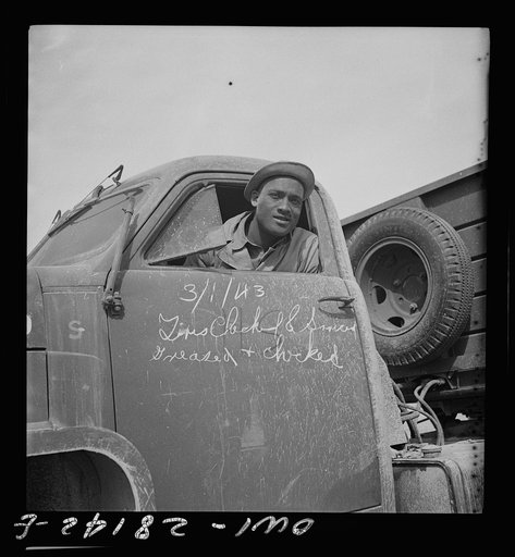 Somewhere on the Persian corridor with a United States Army truck convoy carrying supplies for the aid of Russia. A colored soldier driver is all set to go