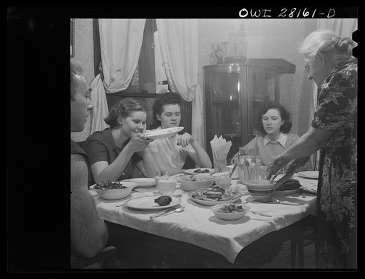 Niagara Falls, New York. War workers who live at Mrs. Hannegan's boardinghouse having supper at 5:30