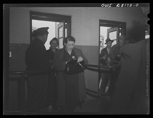 Untitled photo, possibly related to: Niagara Falls, New York. All workers must show their badges and insides of their lunch boxes and packages to the guards at the gate when they enter and leave the Bell Aircraft plant