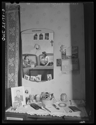 Niagara Falls, New York. Elaine Colgan's bureau in Mrs. Hannegan's boardinghouse. In the mirror she can be seen reading a letter from home to her roommate, Alice. Girls live two and three in a room; pay eight dollars a week board. Receiving and writing letters is their favorite pastime