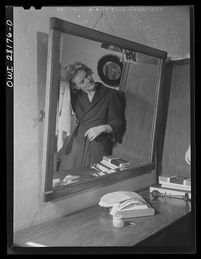 Niagara Falls, New York. Nan Hannegan drying her hair. A chemical operator in a war plant, she must keep her head covered all day, and finds her hair needs washing frequently