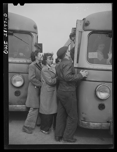 Niagara Falls, New York. Elaine Colgan, second from the left, worker at the Bell Aircraft plant crowding onto a bus after finishing work at 4:30 p.m.