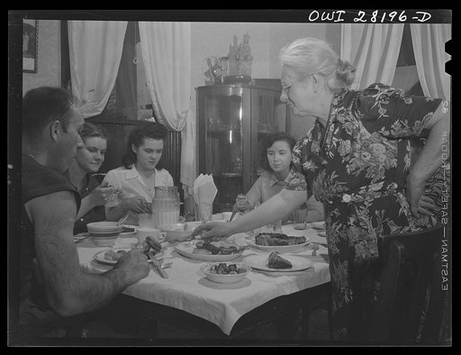 Niagara Falls, New York. War workers who live at Mrs. Hannegan's boardinghouse having supper at 5:30