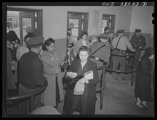 Untitled photo, possibly related to: Niagara Falls, New York. All workers must show their badges and insides of their lunch boxes and packages to the guards at the gate when they enter and leave the Bell Aircraft plant
