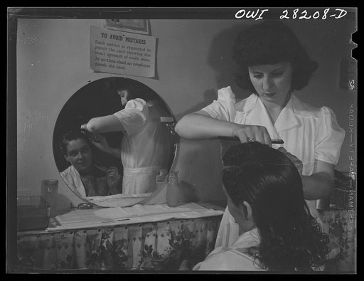Buffalo, New York. Mrs. Grimm, a twenty-six year old widow with six children who is a crane operator at Pratt and Letchworth, having her hair done after work