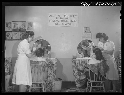 Buffalo, New York. Mrs. Grimm, a twenty-six year old widow with six children who is a crane operator at Pratt and Letchworth, having her hair done after work
