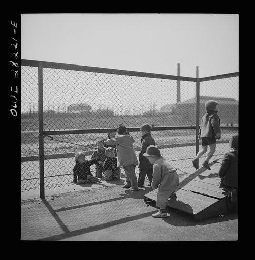 Buffalo, New York. Lakeview nursery school for children of working mothers, operated by the Board of Education at a tuition fee of three dollars weekly. Children from outside looking into the nursery school yard longingly