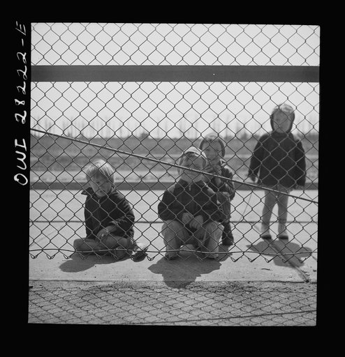 Buffalo, New York. Lakeview nursery school for children of working mothers, operated by the Board of Education at a tuition fee of three dollars weekly. Children from outside looking into the nursery school yard longingly