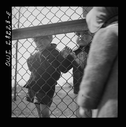 Buffalo, New York. Lakeview nursery school for children of working mothers, operated by the Board of Education at a tuition fee of three dollars weekly. Children from outside looking into the nursery school yard longingly