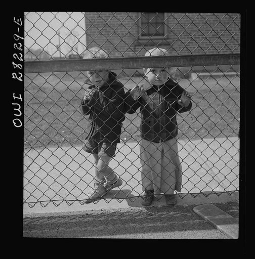 Buffalo, New York. Lakeview nursery school for children of working mothers, operated by the Board of Education at a tuition fee of three dollars weekly. Children from outside looking into the nursery school yard longingly