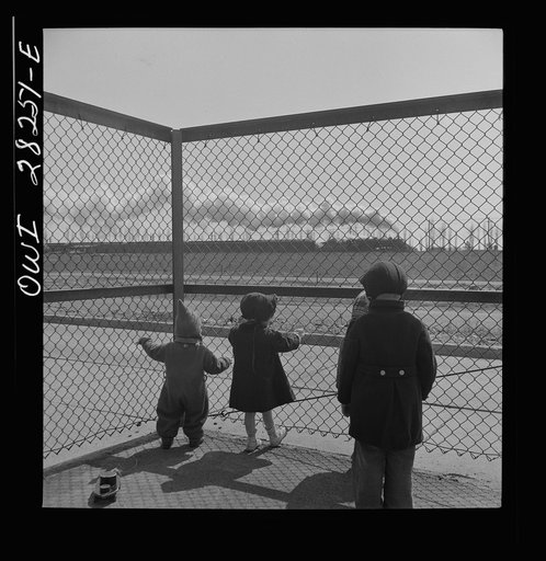 Buffalo, New York. Lakeview nursery school for children of working mothers, operated by the Board of Education at a tuition fee of three dollars weekly. Children stop playing in the yard to watch a train go by