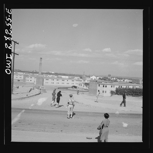 Arlington Farms, war duration residence halls. Crossing road in the front of Arlington farms. A military policeman acts as traffic officer