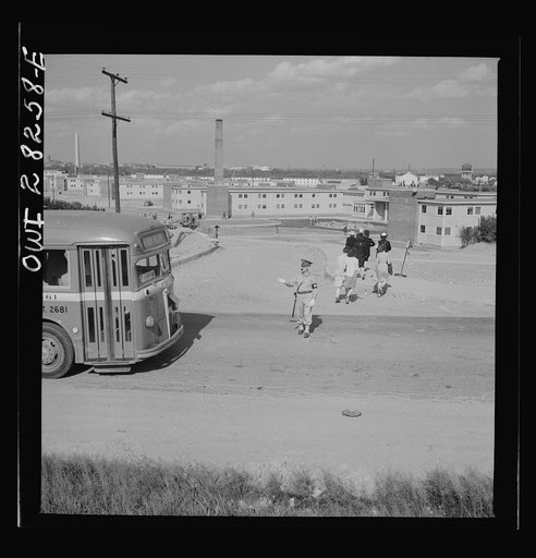Arlington Farms, war duration residence halls. Crossing road in the front of Arlington Farms. A military police man acts as a traffic officer