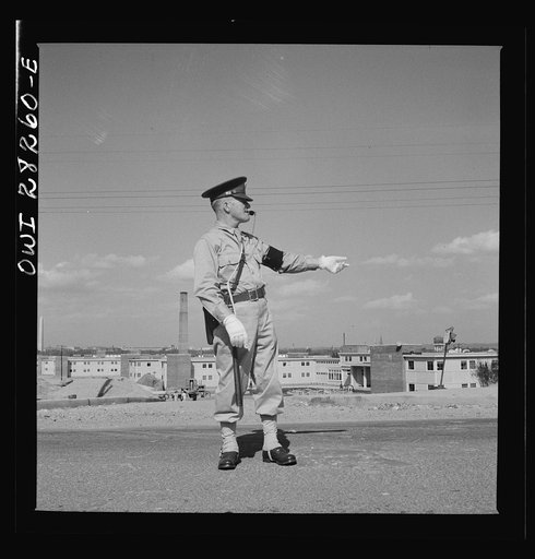 Arlington Farms, war duration residence halls. Military Police acting as traffic officer by the bus stop at Arlington Farms